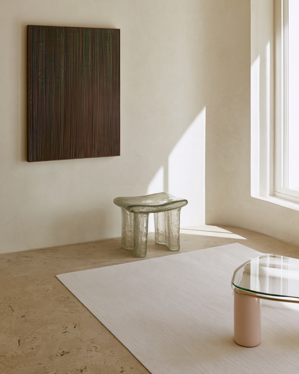 studio placement, Strata, a textured abstract painting with fine vertical raised lines in dark green, burgundy, bronze and earthy tones, framed in dark wood.
