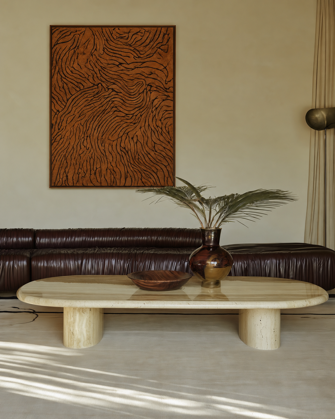 Terracotta Veins, a large textured abstract painting with flowing black lines on a warm rust-brown surface, framed in dark wood above a brown leather sofa.