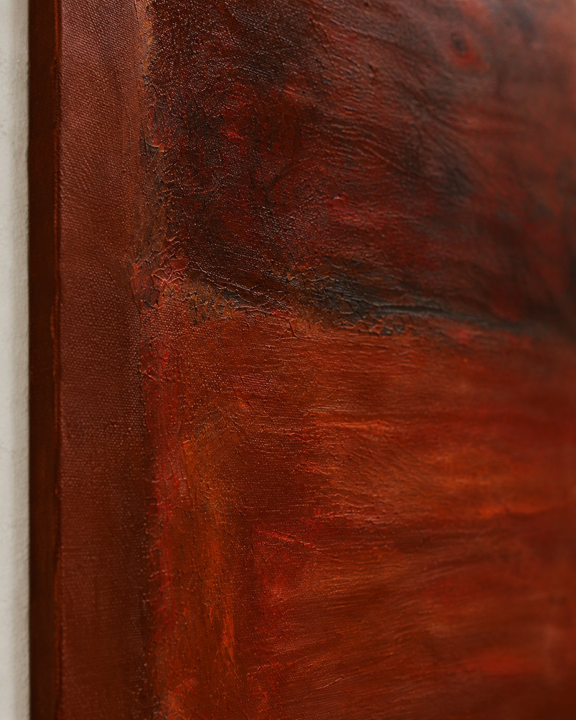 Umbre, a textured abstract painting in deep burgundy, rust red and burnt sienna, featuring a dark central composition with irregular layered edges.